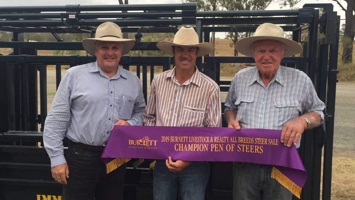 Judge Terry Nolan, Nolan Meats, Gympie, and grand champion pen exhibitors Alan and Neil Goodland from Clare, Theodore, with their prize Leicht's CIA vet crush.