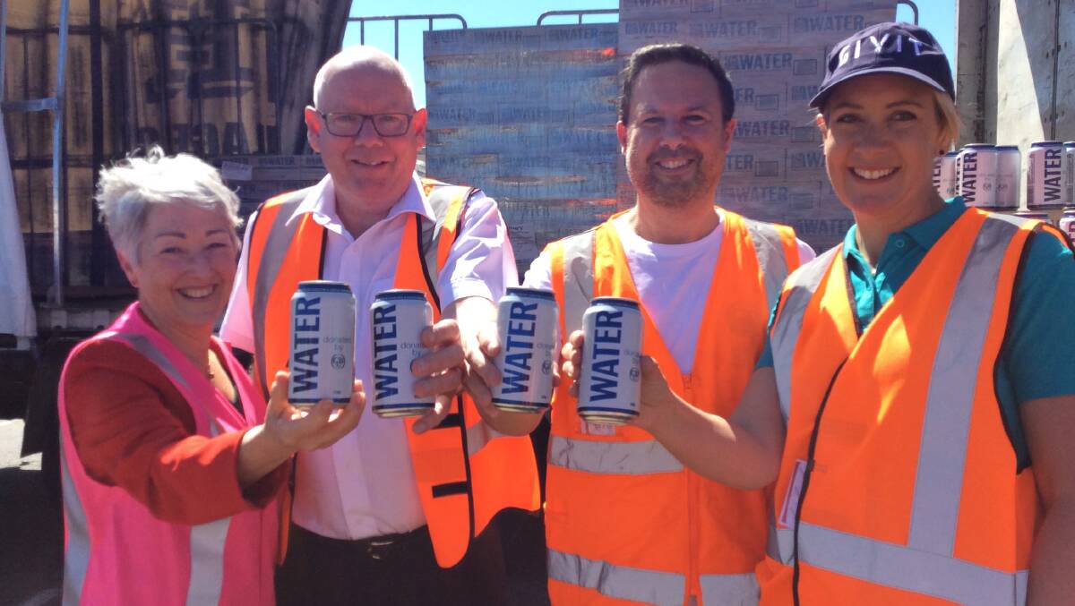 Celebrating the donation of 13,000 cans of drinking water to the Southern Downs region.