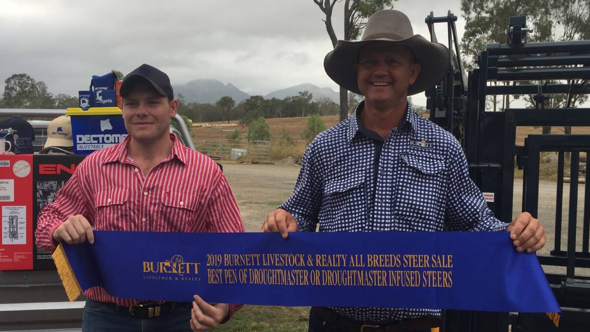 Caleb Crush, C-Crest, Biggenden, exhibited the top pen of Droughtmaster steers. He is pictured with Lance Whitaker from Burnett Livestock.