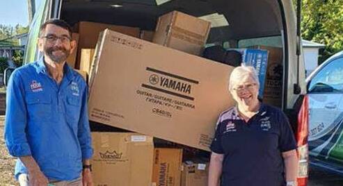 Rural Aid Community Support team members Grant Miskimmin and Julia Hahn a trailer full of musical instruments to be delivered to country schools.