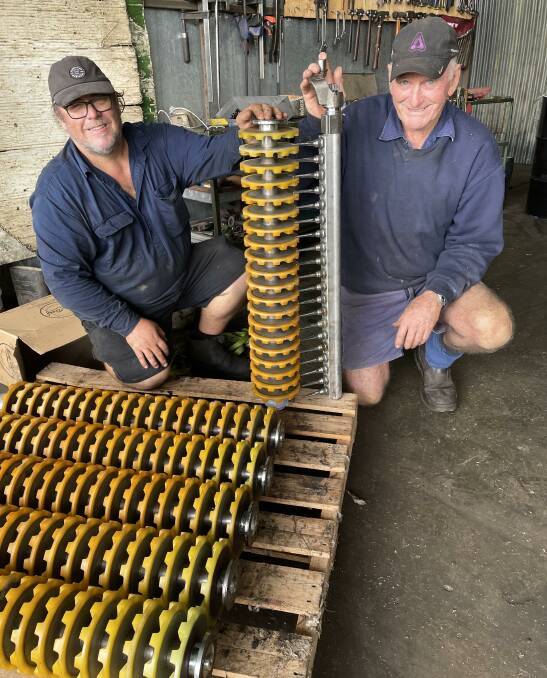Alan Griffiths and Roger North, Goondi Picker Services, with rebuilt doffer and spindle assembly ready to go back into a cotton picker.