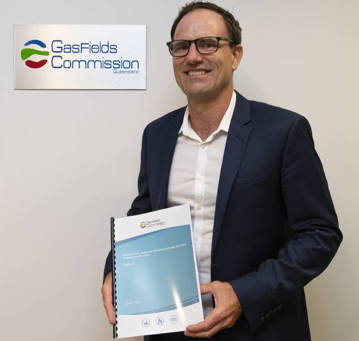 GasFields Commission Queensland acting CEO Warwick Squire with the Review of the Regional Planning Interests Act 2014 Assessment Process Report. 