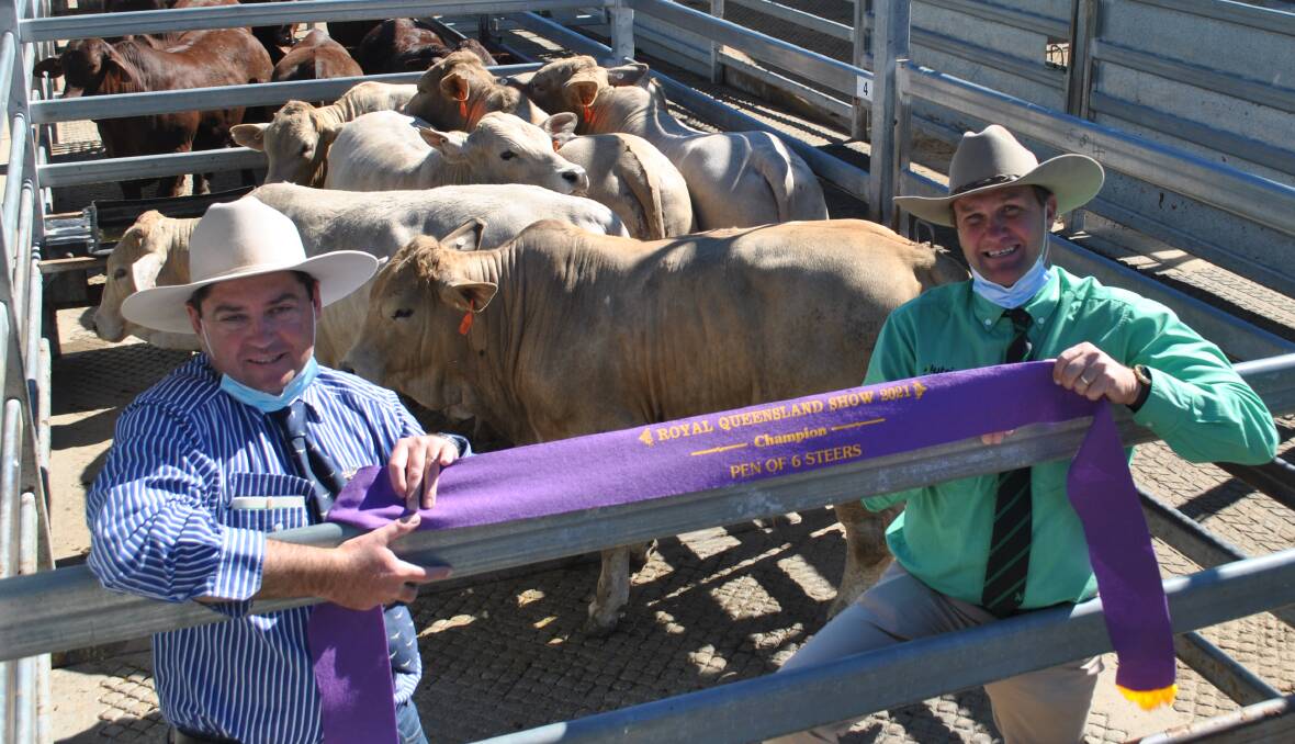 Stanhope Cattle, Wondai, had the champion pen of six steers. Pictured are judge Anthony Griffiths, JBS Australia, and steward Craig Bell, Nutrien.